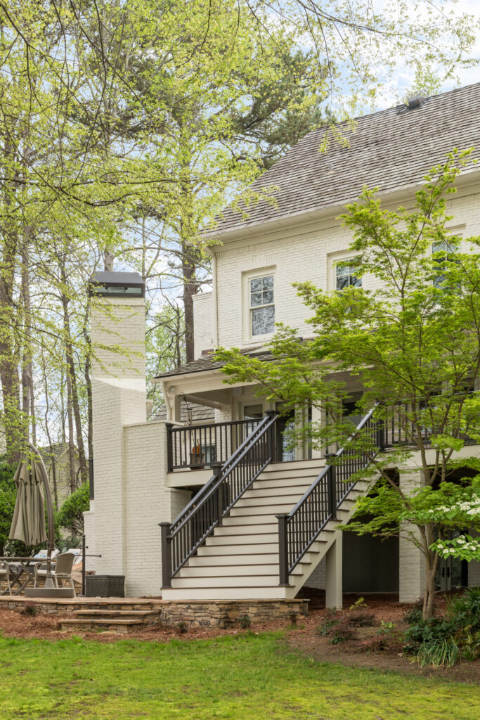 a large white house with stairs leading up to it
