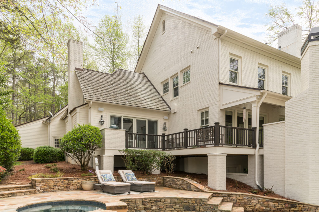 a large white house with a hot tub in front of it