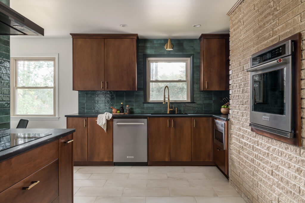 a kitchen with a stove, sink, and oven