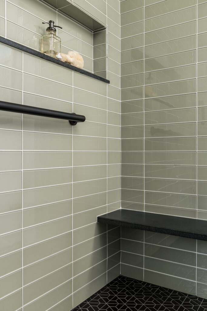 a black and white tiled bathroom with shelves