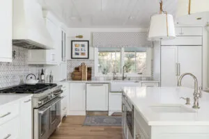 a kitchen with white cabinets and a wood floor