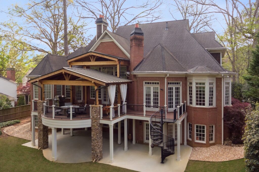 an aerial view of a large house with a deck