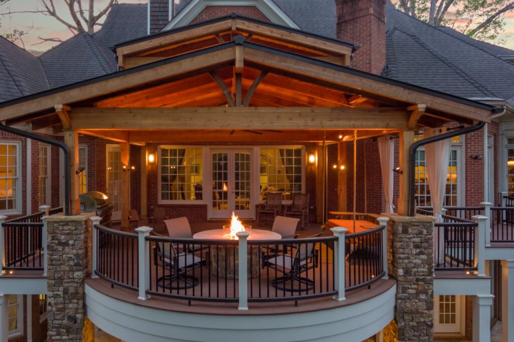 refined rustic porch and deck remodel in Sandy Springs, Georgia, with a fire table