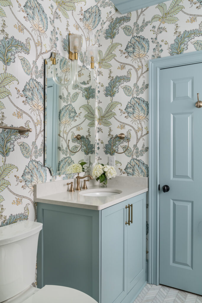 a white toilet sitting next to a blue door