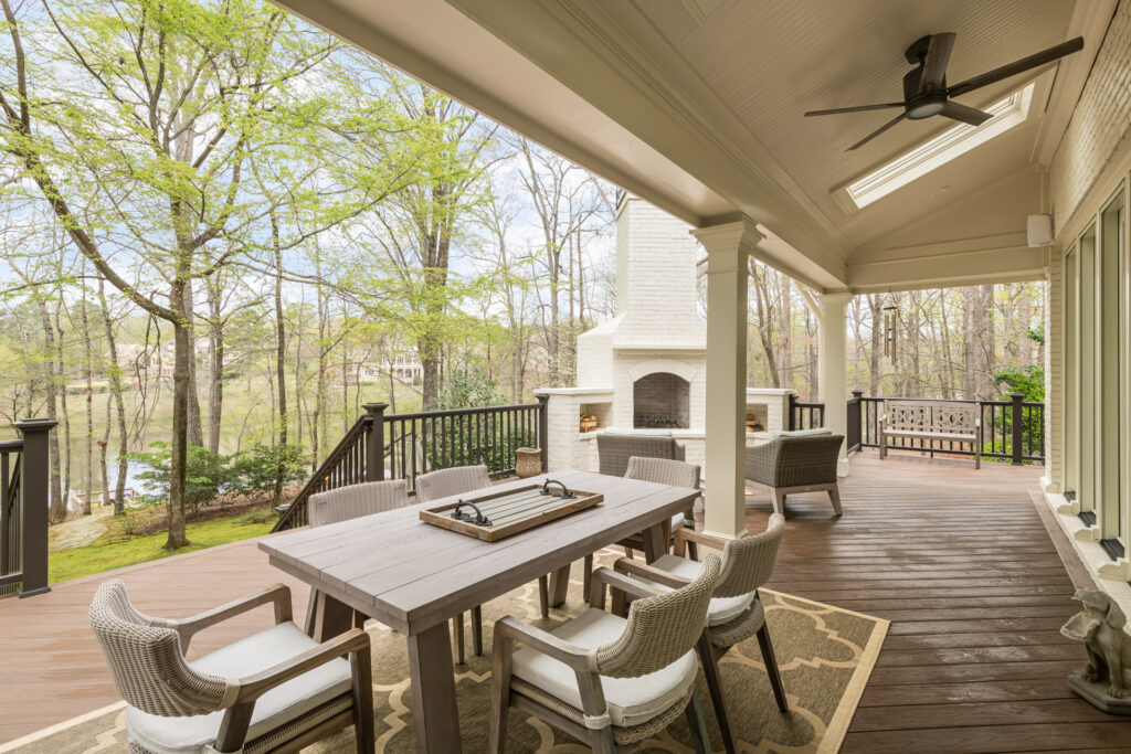 a covered porch with a table and chairs