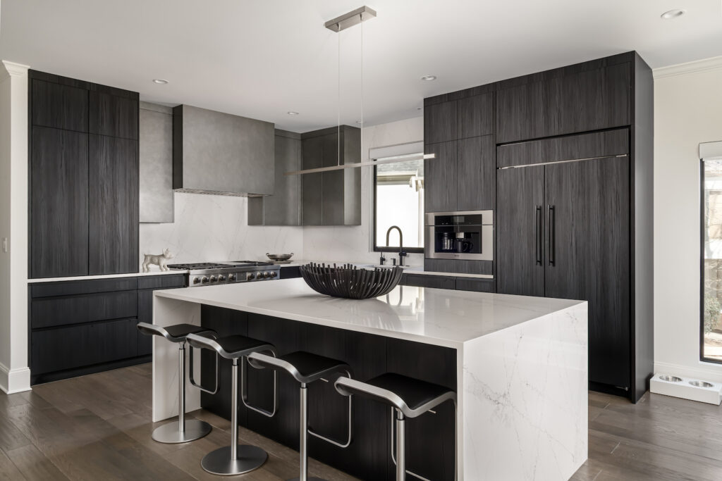 Minimalist Modern Kitchen a large kitchen with a center island and bar stools