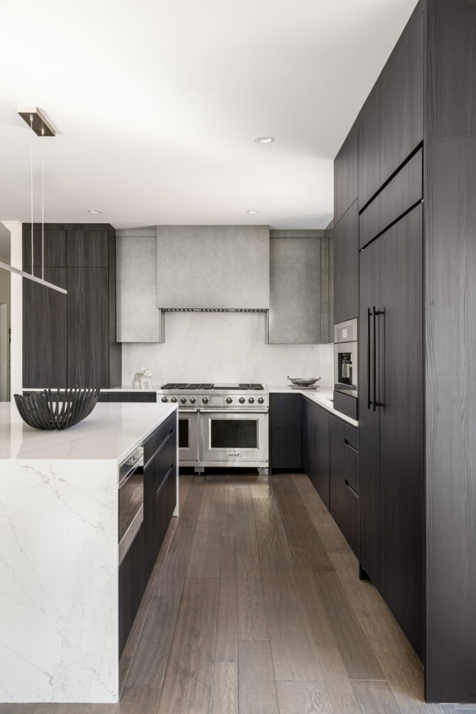 Minimalist Modern Kitchen a kitchen with a marble counter top and wooden floors built-in coffeemaker