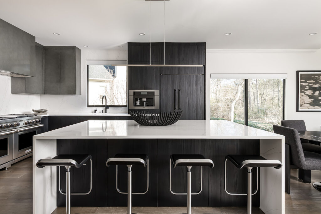 Minimalist Modern Kitchen a large kitchen with a center island and bar stools