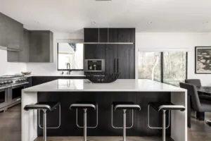 a large kitchen with a center island and bar stools
