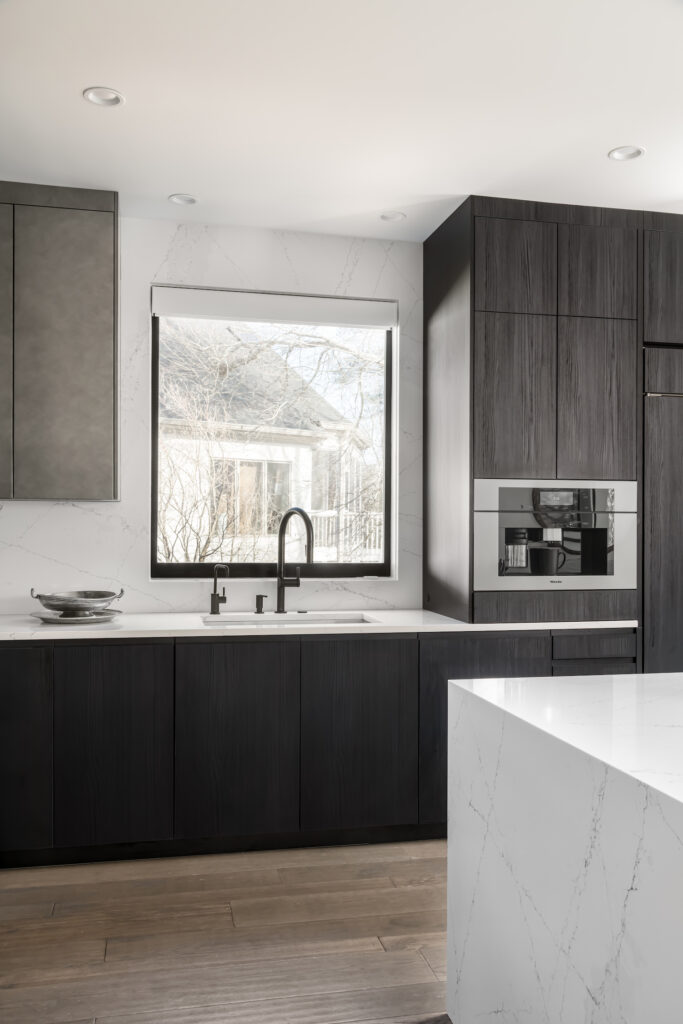 a large kitchen with a marble island in the middle of it