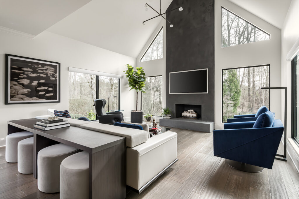 a large living room with a fireplace and large windows