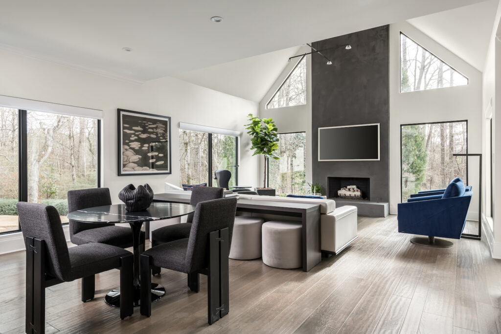a dining room with a glass table surrounded by chairs