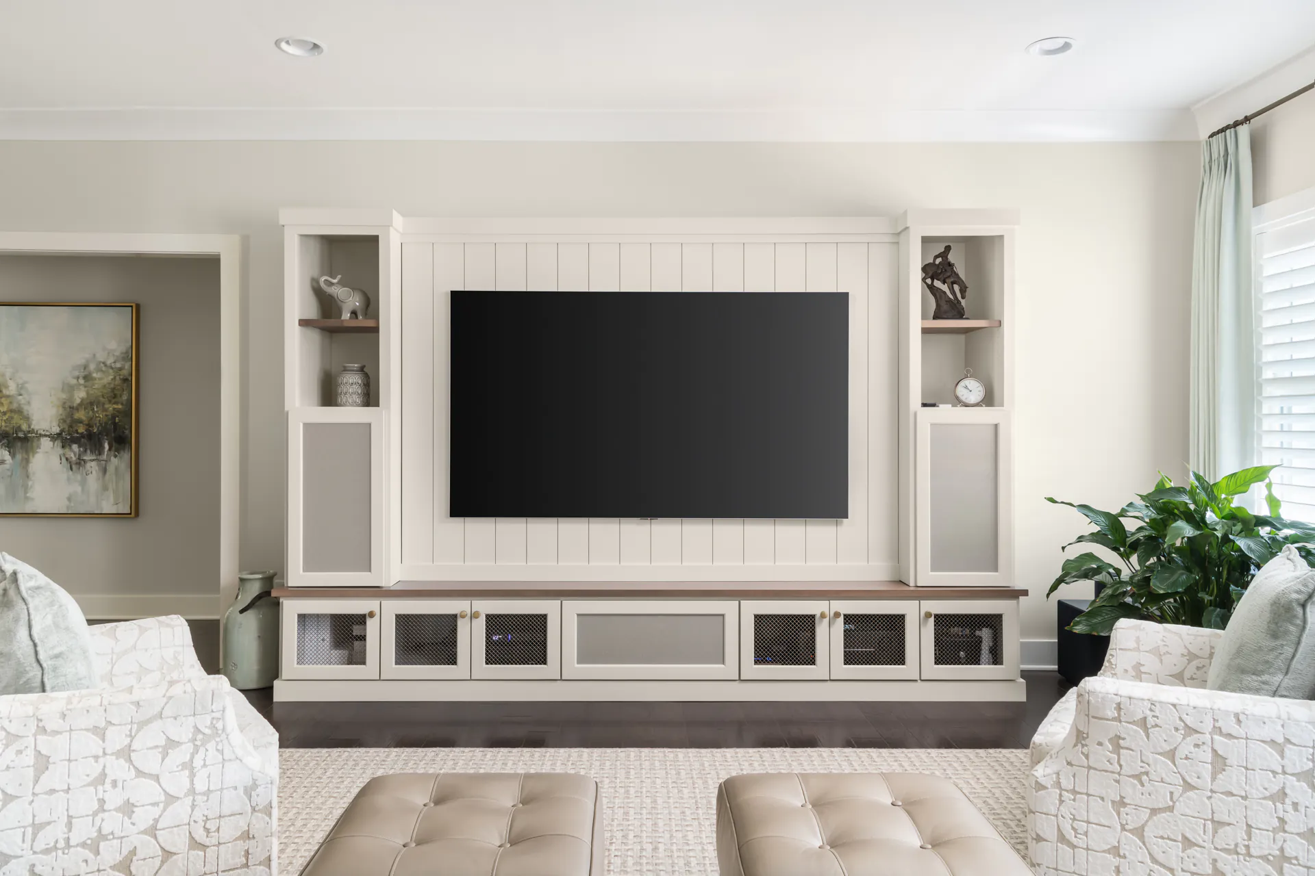 a living room with white furniture and a flat screen tv