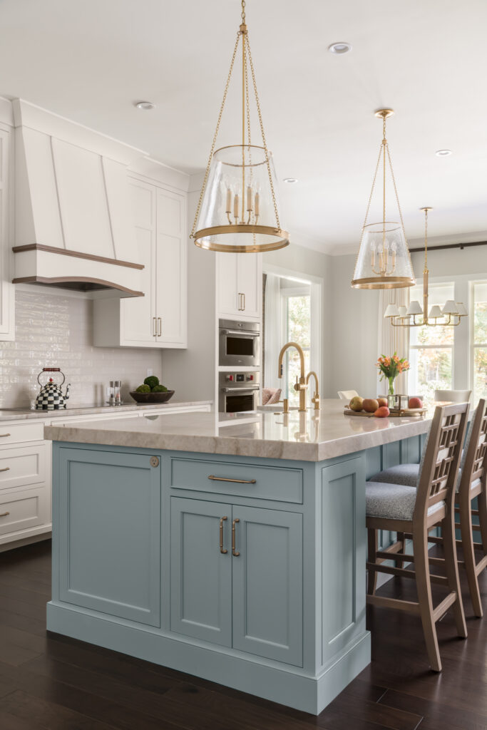 a large kitchen with a center island surrounded by chairs