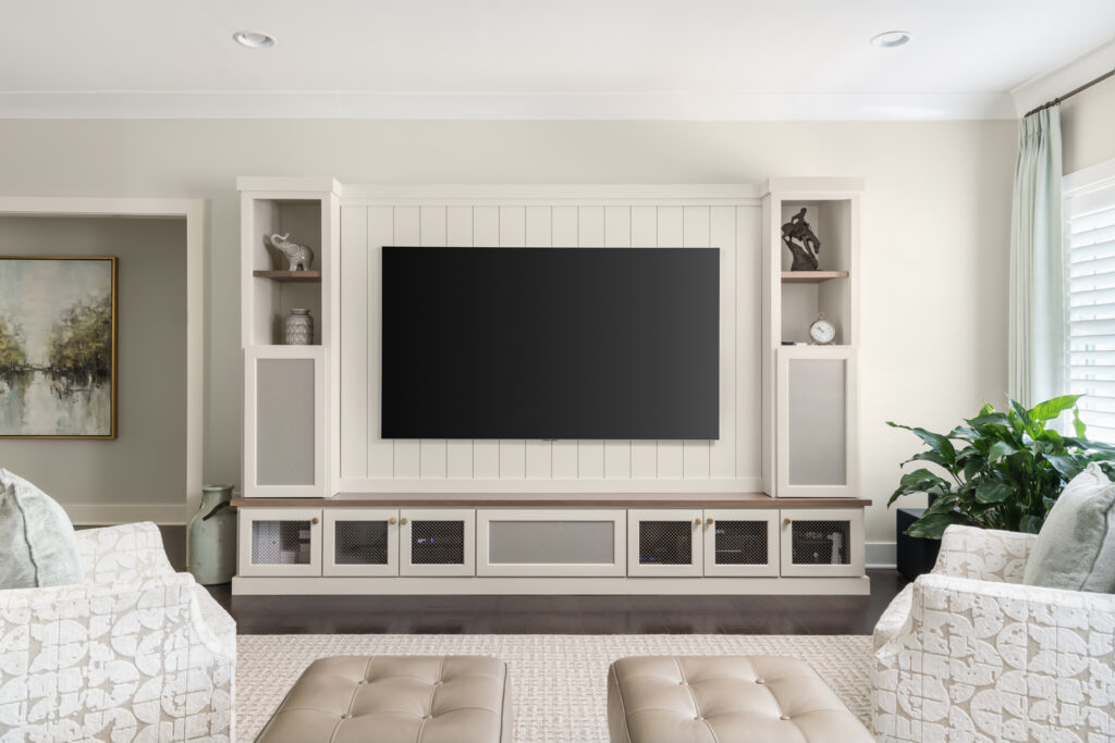 a living room with white furniture and a flat screen tv