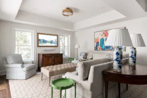 a living room filled with furniture and a painting on the wall