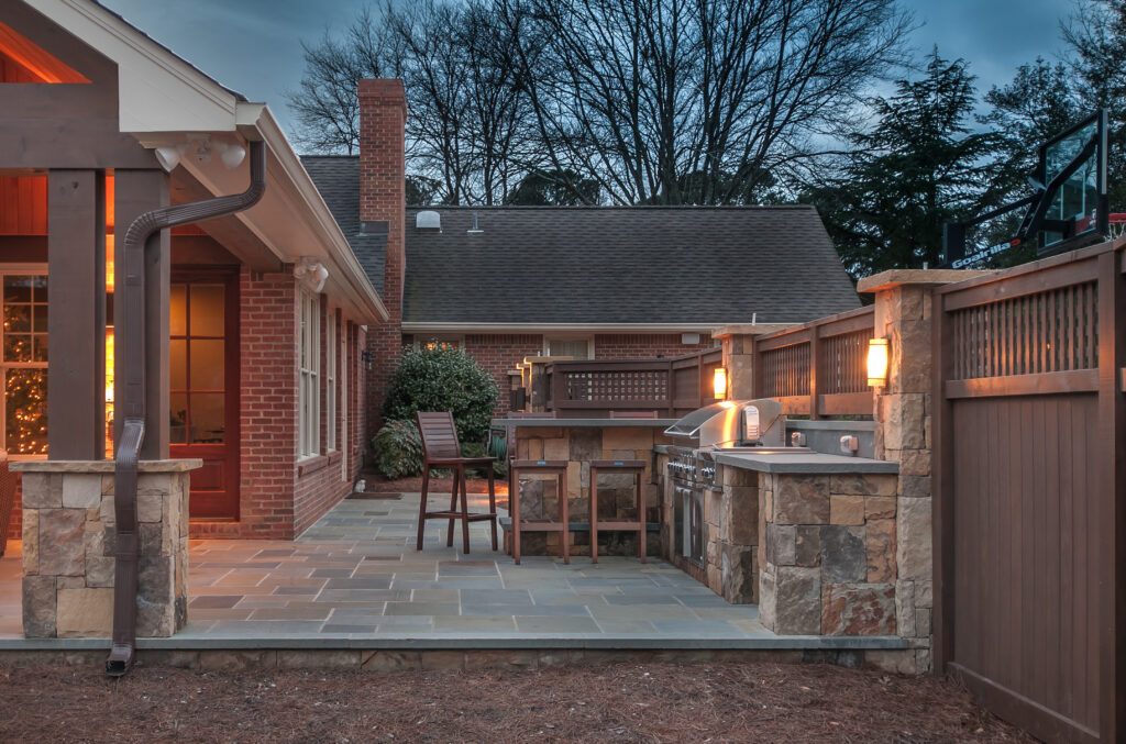 a backyard with a grill and a patio