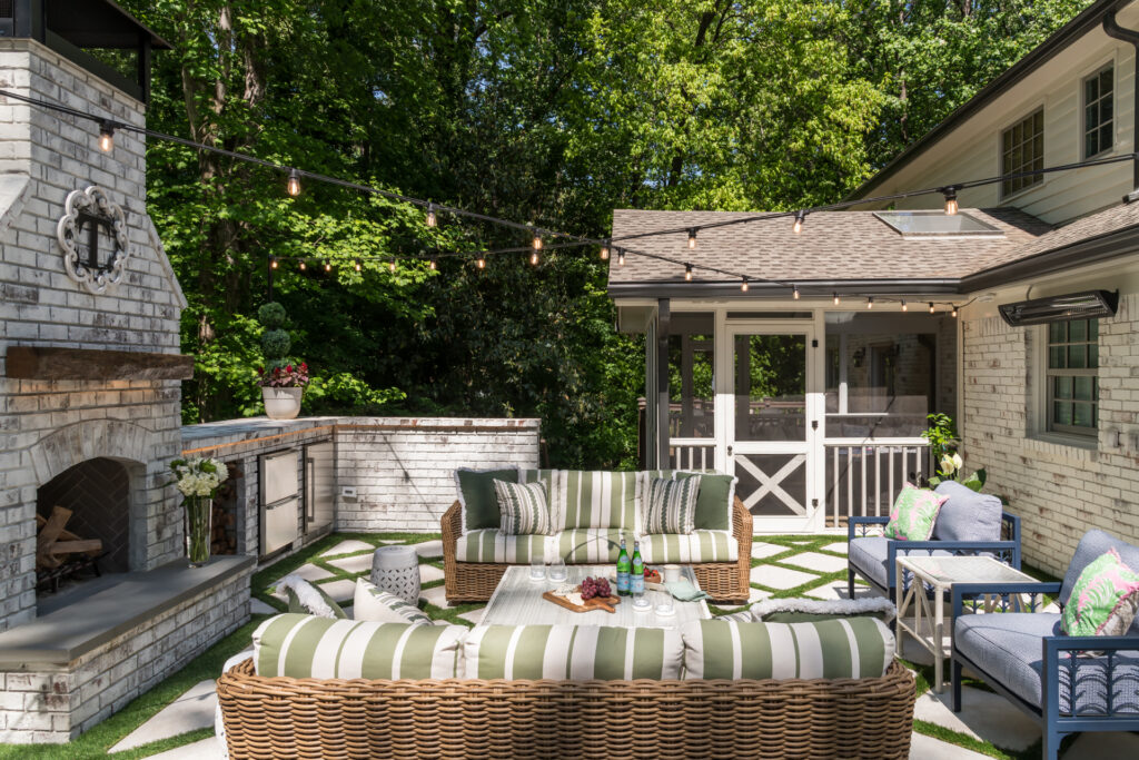 outdoor living space terrace with outdoor fireplace and party lights