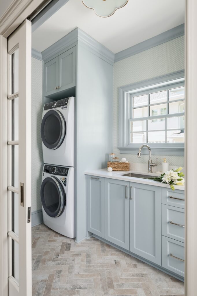 A laundry room-mudroom addition in Buckhead with stackable washer dryer, sink, window and cabinets