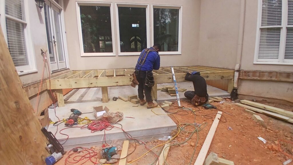 Innovative Design•Build hard at work rebuilding a deck from scratch in johns creek, georgia